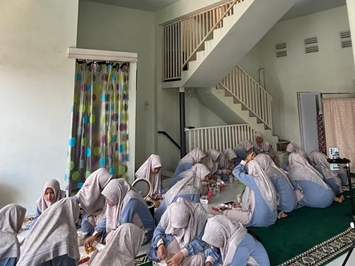 Santri putri murojaah hafalan Al-Qur'an berjamaah di ruang asrama